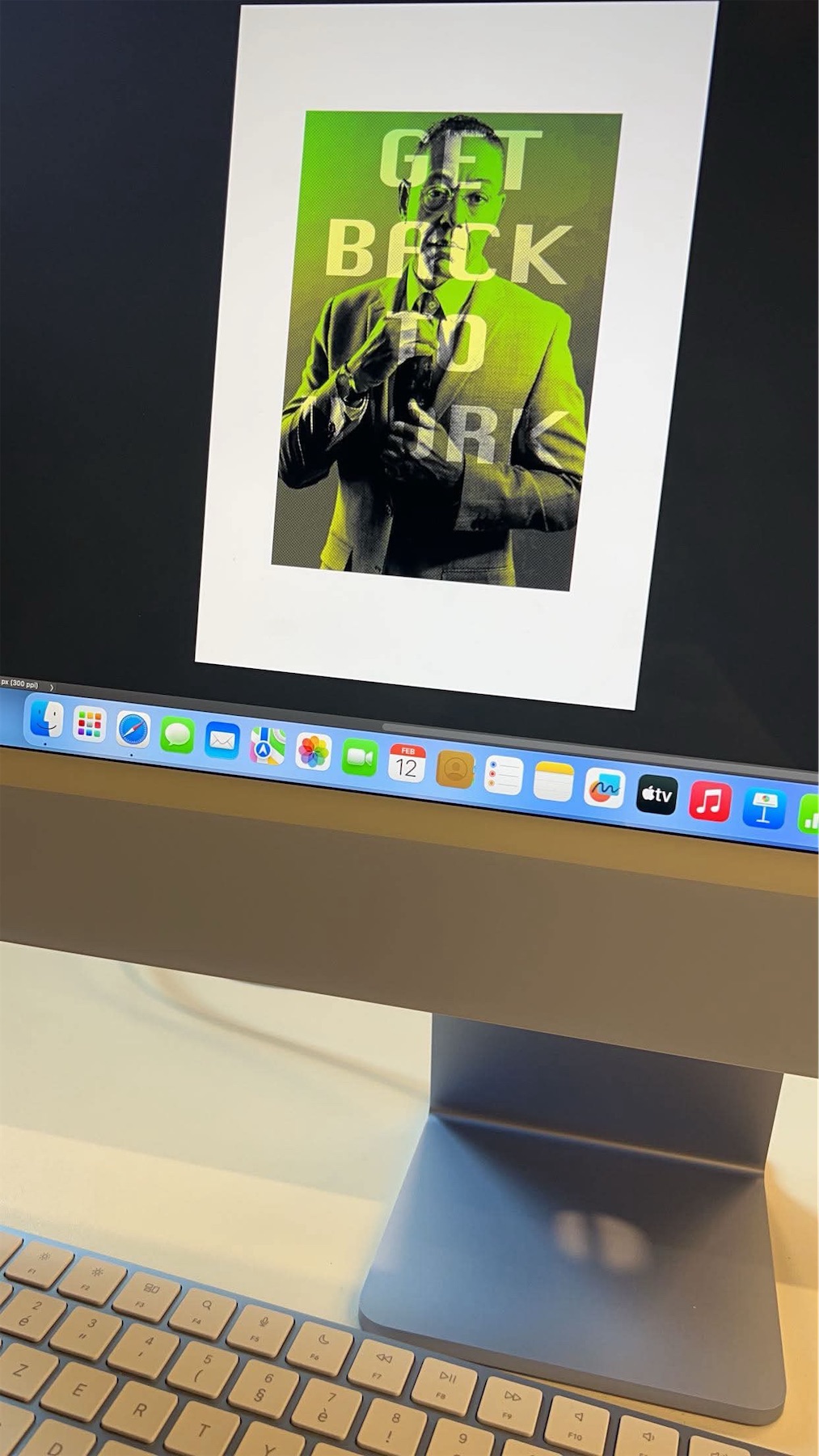 Poster on a computer screen: a portrait in bright green tones with the large text Get Back to Work.